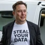 Elon Musk wearing a t-shirt that says "Steal Your Data"